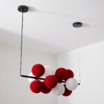 Modern chandelier with red and white spheres, featuring a contemporary design. - Image 3